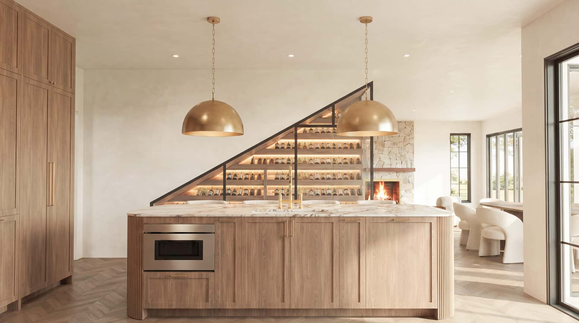 A kitchen on the boards: marble island, brass pendants, white oak.