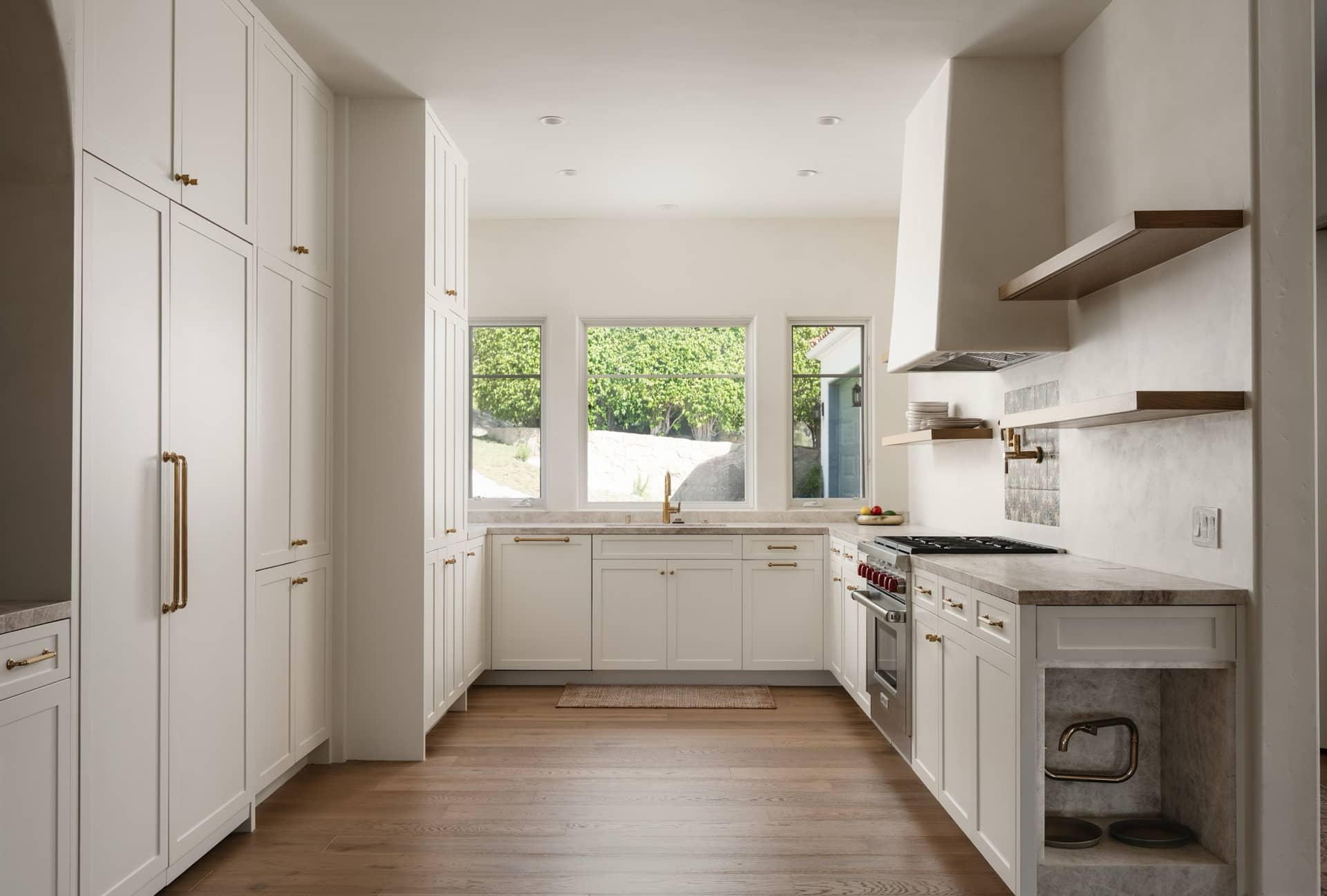 A Mission Canyon kitchen with a plaster hood and oak shelving.