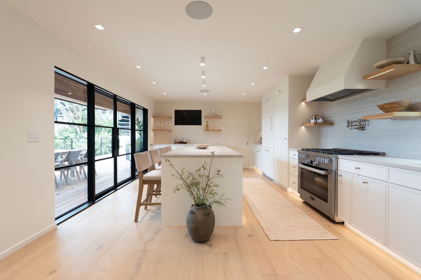A renovated kitchen with steel framed glass doors opening to the garden.